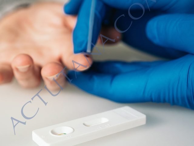 Close-up shot of a doctor doing a rapid test for the detection of Covid-19 on white background. Quickly spread the respiratory virus. Massive tests to avoid contagion and start de-escalation.